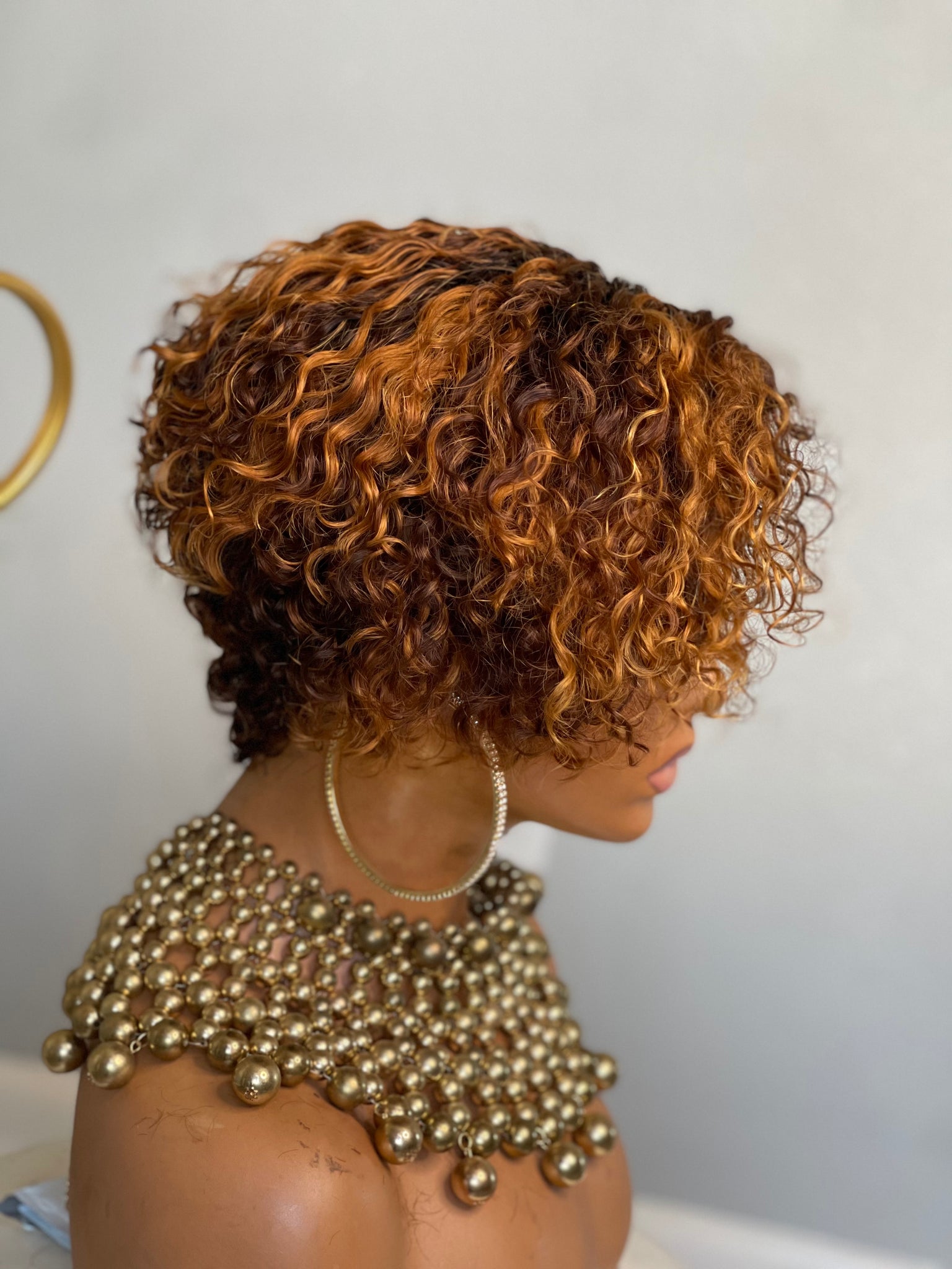 Short glueless pixie wig with highlights, adding warmth and dimension for African American hair.