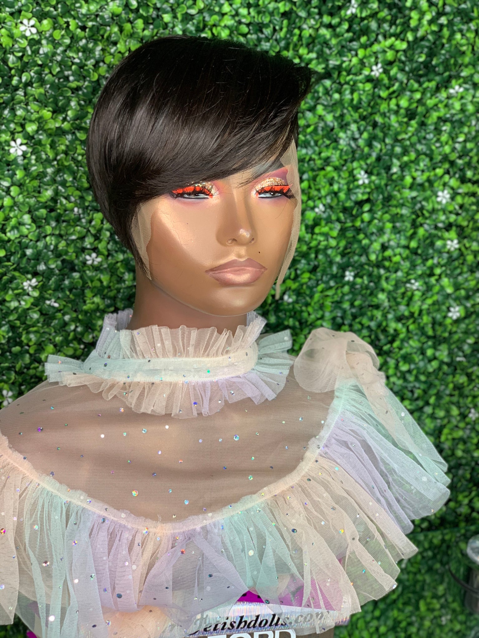 Razor cut bob wig with feathered edges for a soft, voluminous effect.