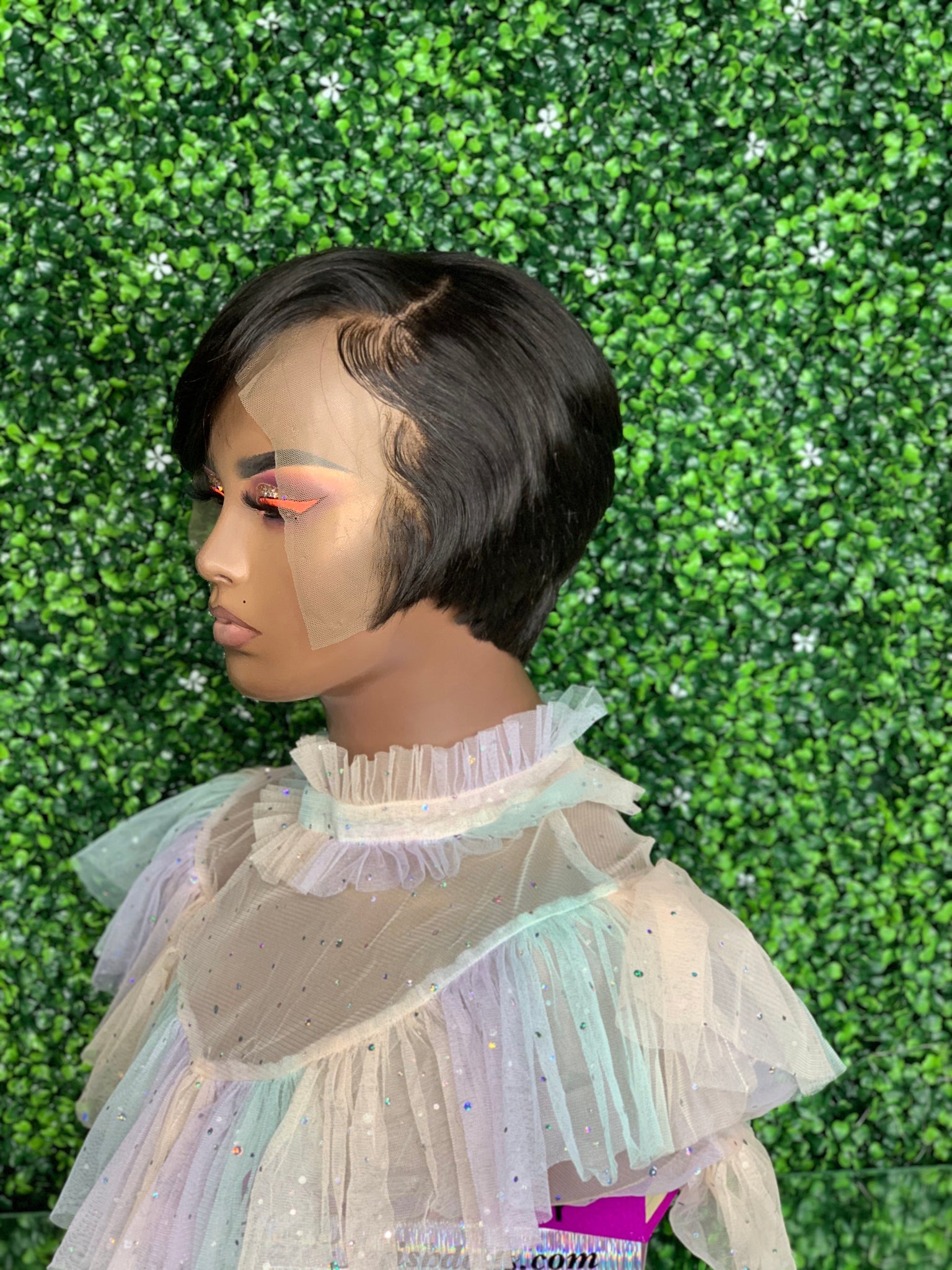 Razor cut bob wig with feathered edges for a soft, voluminous effect.