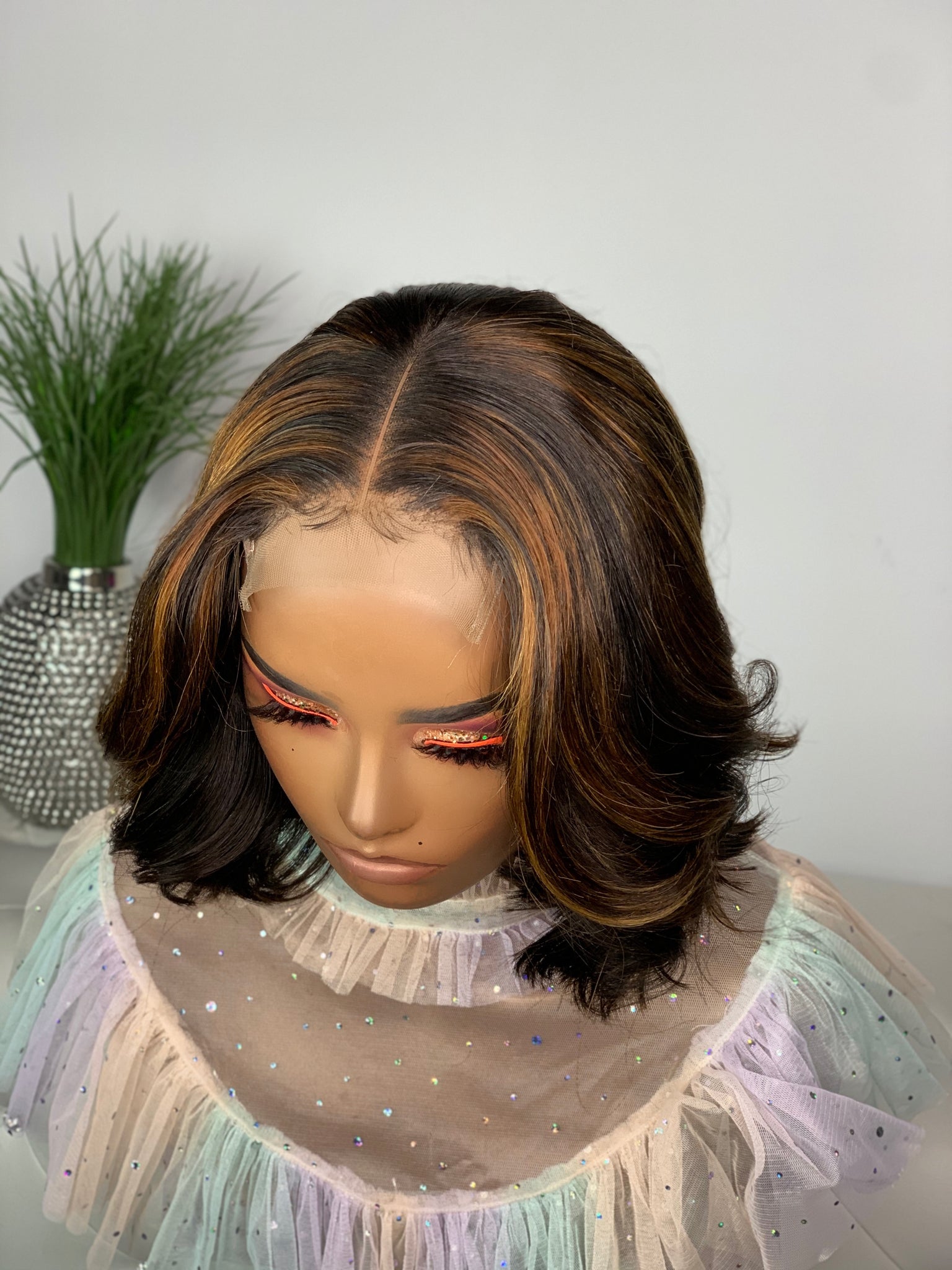 Short glueless bob wig with a soft curl pattern for a feminine look.