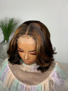 Short glueless bob wig with a soft curl pattern for a feminine look.